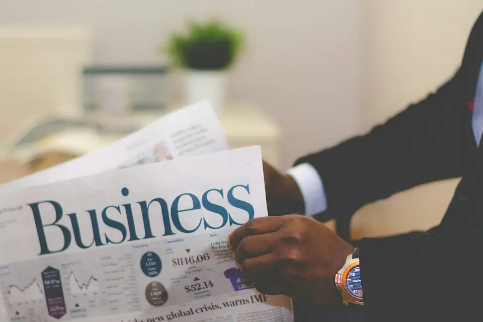 A business professional reading the business section of a newspaper