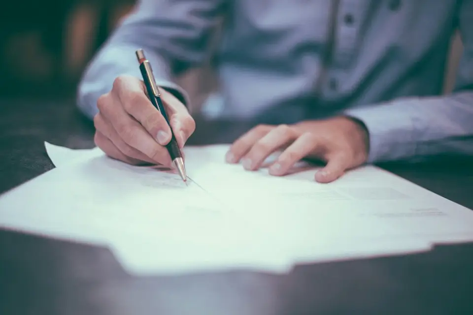 A person reviewing and signing policy documents