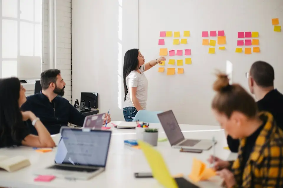 A team mapping out strategy on a wall of sticky notes